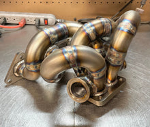 Load image into Gallery viewer, CCdesign 1G/2G DSM Divided T4 Bottom Mount Turbo Manifold